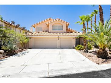 Charming two-story home with a two-car garage, desert landscaping, and a tile roof at 8875 Tidal Bay Dr, Las Vegas, NV 89117