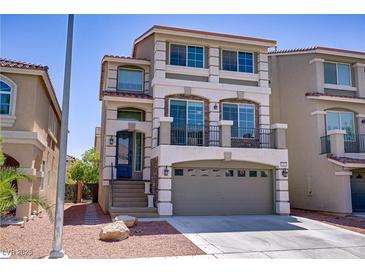 Inviting three-story home featuring a two-car garage and a charming second story balcony at 9784 Kodiak Island Ct, Las Vegas, NV 89141