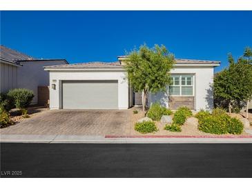 Charming single story home featuring a two car garage, desert landscaping, and bright stucco at , Las Vegas, NV 89166