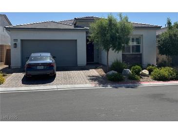 Charming single-story home features a two-car garage and a beautifully landscaped front yard at , Las Vegas, NV 89166