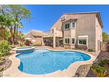 Inviting backyard oasis with pool, hot tub, and outdoor kitchen perfect for entertaining at 11219 Playa Bonita Ave, Las Vegas, NV 89138