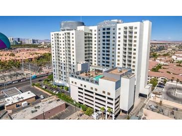 Exterior view of the Platinum Hotel and Spa featuring a rooftop pool and surrounding buildings at 211 E Flamingo Rd # 402, Las Vegas, NV 89169