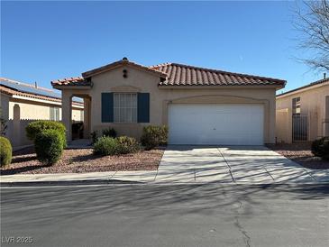 Charming single-story home featuring a well-maintained front yard and a two-car garage at 338 Brilliant Summit Cir, Henderson, NV 89052