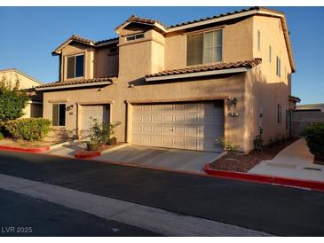 Charming stucco home featuring a two-car garage, manicured landscaping and a warm, inviting atmosphere at 37 Belle Soleil Ave, Las Vegas, NV 89123