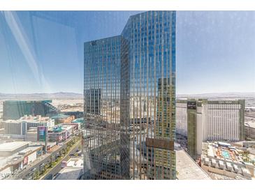 Striking high-rise building with expansive glass windows showcasing a modern architectural design and vibrant city views at 3722 Las Vegas Blvd # 3209, Las Vegas, NV 89158
