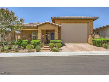 Charming single-story home showcasing desert landscaping and a warm, inviting entrance, complete with a two-car garage at 412 Middlestone Ave, Henderson, NV 89011