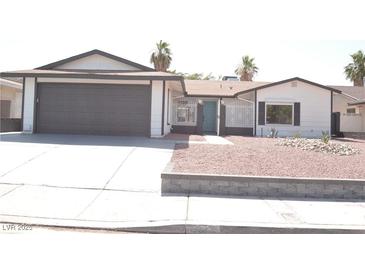 Charming single-story home with a gray garage door and desert landscaping at 4277 Rimcrest Rd, Las Vegas, NV 89121