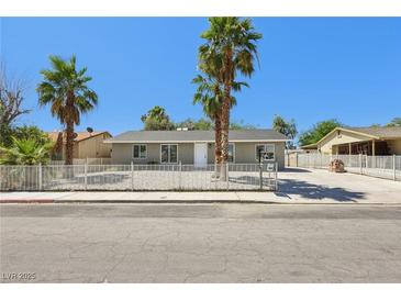 Charming single-story home with desert landscaping and mature palm trees at 4825 Stillwater Ave, Las Vegas, NV 89110