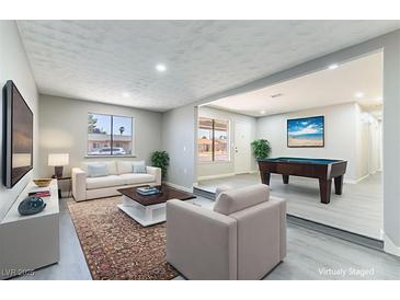 Comfortable living room with modern decor, featuring a billiard table and stylish furniture at 5800 Auborn Ave, Las Vegas, NV 89108