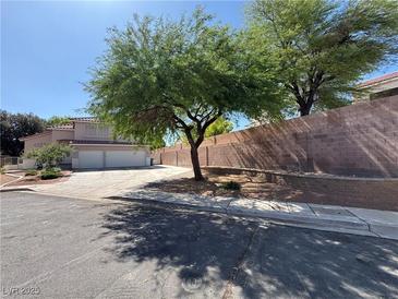Charming home with a three-car garage and mature landscaping in a quiet residential neighborhood at 6293 Pavestone Ln, Las Vegas, NV 89142