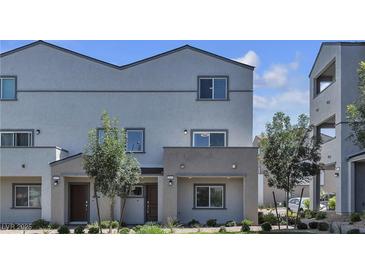 A charming townhome featuring a covered entryway, neutral stucco, and well-maintained landscaping at 8436 Noir Ave, Las Vegas, NV 89129