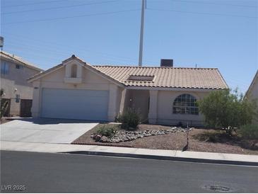 Charming single-story home features a desert landscape, and an attached two-car garage at 918 Ambusher St, Henderson, NV 89014