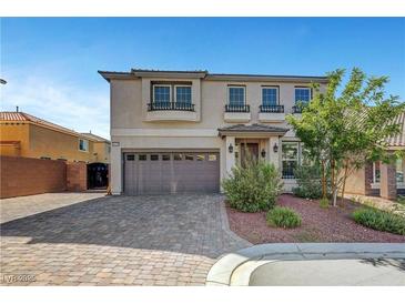 Attractive two-story home featuring a neutral color scheme and beautiful front yard landscaping at 10325 Quartz Reef Ct, Las Vegas, NV 89141