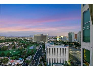 Expansive city view featuring a golf course and the iconic Las Vegas skyline at dusk at 322 Karen Ave # 2501, Las Vegas, NV 89109