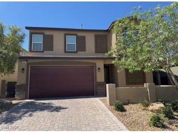 Attractive two-story home boasts a brick driveway, two-car garage, and well-maintained front yard at 4337 Stardusk Falls Ave, North Las Vegas, NV 89084