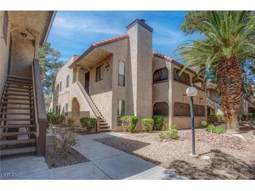 Charming condo exterior with landscaped grounds, stucco facade, and a beautiful palm tree at 4742 Obannon Dr # A, Las Vegas, NV 89102