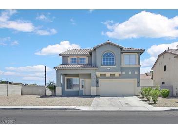 Two-story home featuring desert landscaping and a well-maintained front yard at 5923 Halehaven Dr, Las Vegas, NV 89110