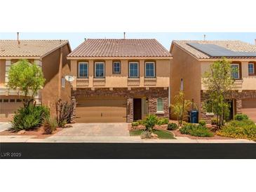 Charming two-story home boasts a stone facade and manicured landscaping at 6014 Belvedere Canyon Ave, Las Vegas, NV 89139