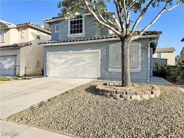 Charming two-story home with a well-maintained front yard and a two-car garage at 6063 Peach Orchard Rd, Las Vegas, NV 89142