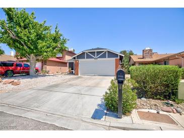 Charming single-story home featuring a two-car garage, desert landscaping, and a mature shade tree at 6924 Senton Ave, Las Vegas, NV 89108