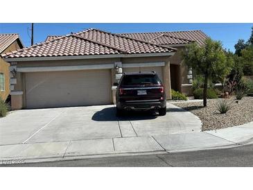 Charming single-story home featuring a spacious driveway, a two-car garage, and desert landscaping at 7559 Chambery Cove Ct, Las Vegas, NV 89123