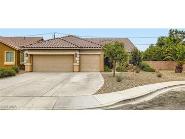 Charming single-story home featuring a desert landscape and a spacious two-car garage at 7559 Chambery Cove Ct, Las Vegas, NV 89123