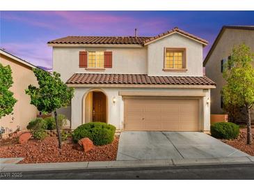 Charming two-story home features a tile roof and a well-maintained front yard at 10557 Bandera Mountain Ln, Las Vegas, NV 89166