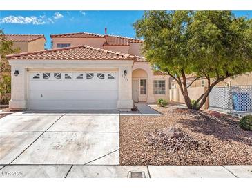 Charming two-story home featuring a spacious two-car garage and classic stucco facade at 1826 Monte Alban Dr, North Las Vegas, NV 89031