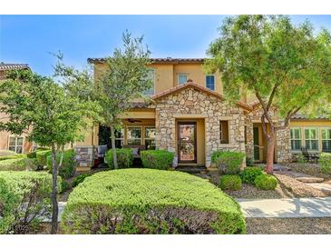 Charming two-story home featuring a stone facade, well-maintained landscaping, and inviting front porch at 2370 Via Firenze, Henderson, NV 89044