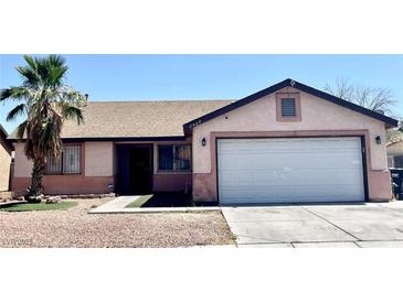 Charming single-story home featuring a well-kept yard with a palm tree and a two-car garage at 2405 Prime Advantage Ave, North Las Vegas, NV 89032