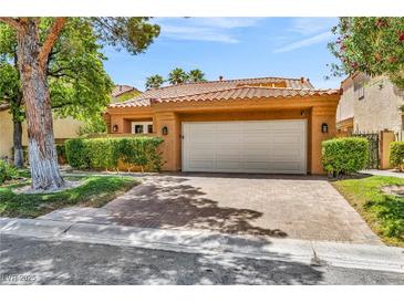Charming single-story home with a well-manicured lawn and a spacious two-car garage at 5123 Southern Hills Ln, Las Vegas, NV 89113
