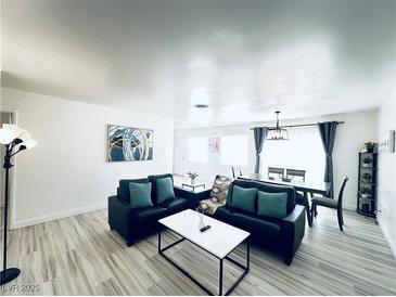 Bright and airy living room with wood floors and modern furnishings at 5821 Marka Dr, Las Vegas, NV 89108
