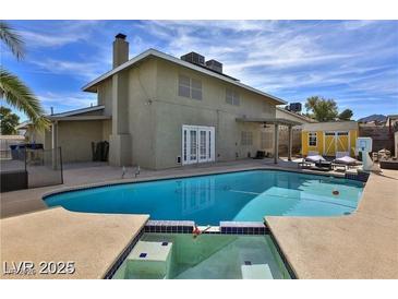 Backyard pool with a diving board, patio, and a bright blue sky at 722 Barrie Ct, Henderson, NV 89002