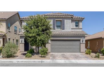 Charming two-story home featuring a two-car garage, desert landscaping, and a well-maintained front yard at 7890 S Miller Ln, Las Vegas, NV 89113