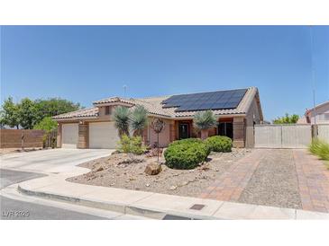 Charming single-story home featuring a well-maintained yard, brick driveway, three-car garage and solar panels at 950 Marbelwood Ave, Las Vegas, NV 89123