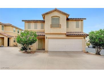 Inviting two-story home with a two car garage and lush landscaping in the front yard at 967 Coronado Peak Ave, Las Vegas, NV 89183