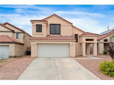 Charming home featuring a two-car garage, desert landscaping, and a red tile roof at 120 Wynntry Dr, Henderson, NV 89074