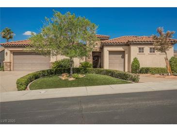 Charming single-story home with a well-manicured lawn, mature landscaping, and a three-car garage at 2080 Powder Springs St, Henderson, NV 89052