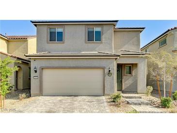 Charming two-story home features a neutral color scheme, attached garage, and well-manicured landscaping at 2531 Dollison Ave, North Las Vegas, NV 89081