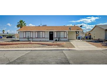 Inviting single-story home featuring a well-manicured front yard and a classic desert landscape at 4047 Maple Hill Rd, Las Vegas, NV 89115
