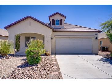 Charming single story home featuring a two-car garage and low-maintenance landscaping in front at 5240 Adorato Dr, North Las Vegas, NV 89031