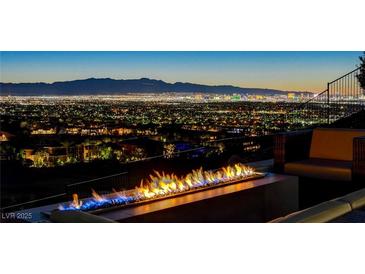 Breathtaking city view with fire pit, perfect for entertaining guests outdoors at night at 527 Serenity Point Dr, Henderson, NV 89012