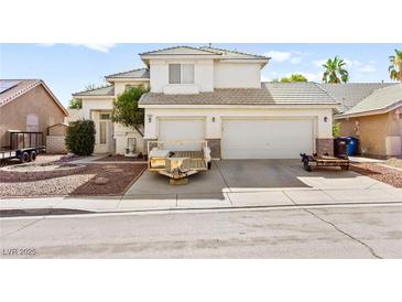 Two-story home featuring a three-car garage and low maintenance landscaping at 5539 Foxtail Ridge St, North Las Vegas, NV 89031