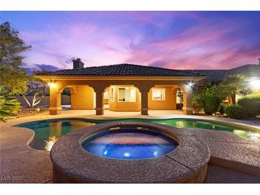 Stunning backyard features a sparkling pool and spa, perfect for outdoor relaxation and entertaining at 5680 N Fort Apache Rd, Las Vegas, NV 89149