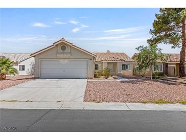 Charming single-story home with a two-car garage, complemented by low maintenance landscaping and a tiled roof at 6209 Lenaking Ave, Las Vegas, NV 89122