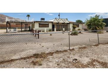 Charming front yard view of home, showing fence, landscaping and elevated deck at 66 Lailani St, Las Vegas, NV 89110