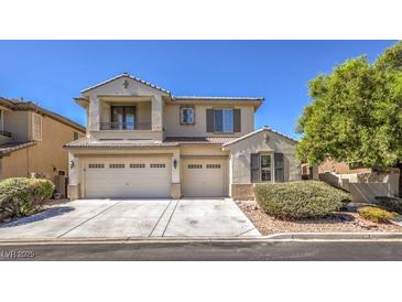 Two-story home with a three-car garage, neutral paint, manicured landscaping, and well-maintained driveway at 7525 Royal Crystal St, Las Vegas, NV 89149