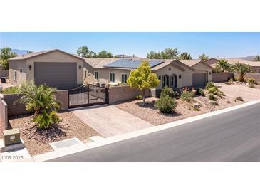 Stunning single-story home with a private gate, solar panels, and lush landscaping at 8713 Long Winter Ct, Las Vegas, NV 89131