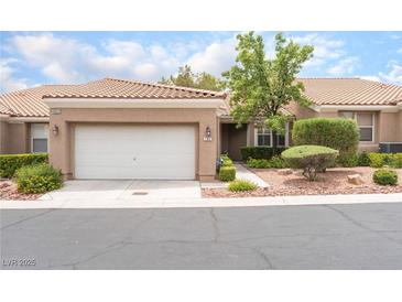 Charming single-story home featuring a well-manicured yard and an attached two-car garage at 10037 Summer Oak Ln # 102, Las Vegas, NV 89134