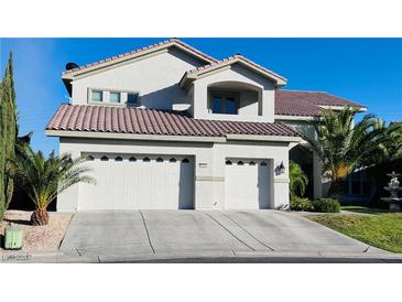 Charming two-story home with a three-car garage, desert landscaping, and a red tile roof at 10234 Renae Nicole Ct, Las Vegas, NV 89183